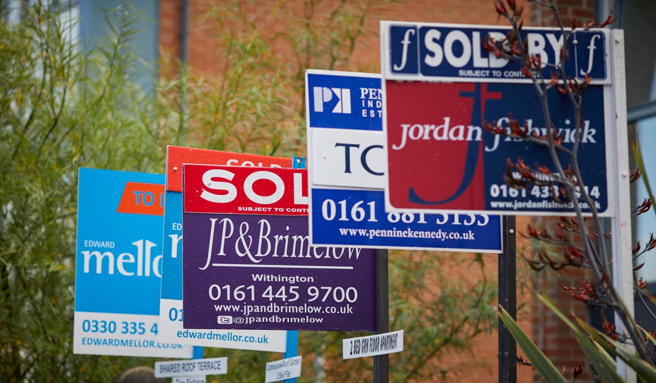 Property sale signs outside an apartment block in Manchester suburb of Fallowfield. Photo: Alamy