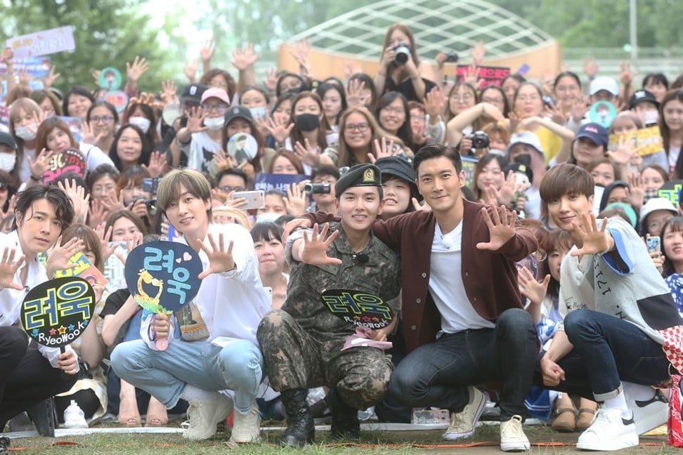 Super Junior members Leeteuk, Eunhyuk, Siwon and Donghae greet Ryeowook (centre) as he completes his military service on Tuesday. Photo: Yonhap