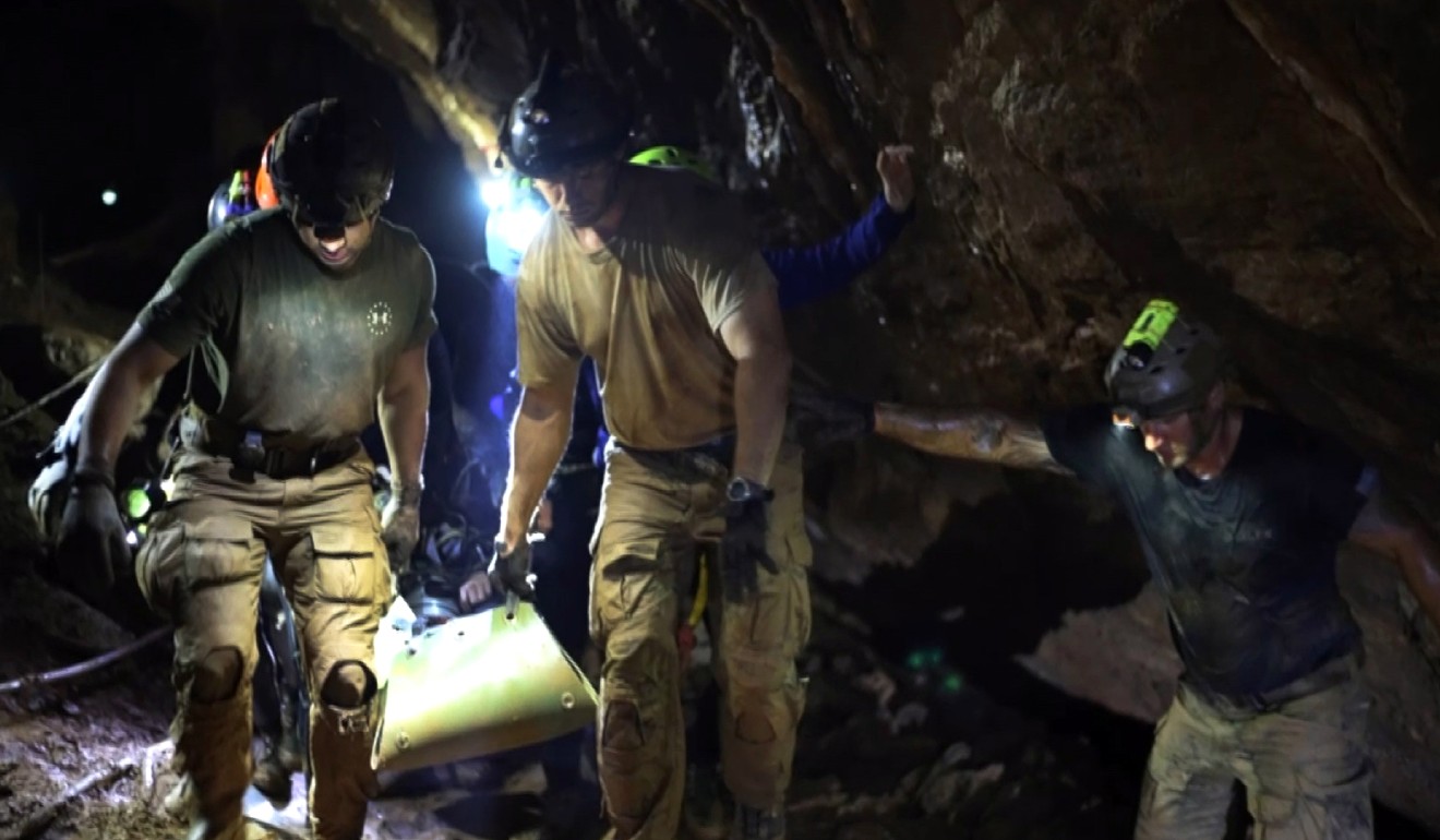 The rescue teams used pulleys, string and rubber tubes to haul a green, kayak-shaped stretcher out of tight crevices. Photo: EPA