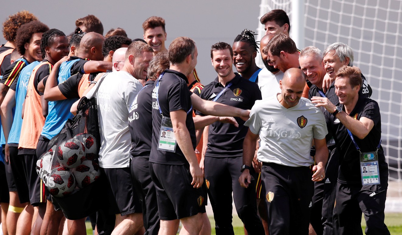 Belgium coach Roberto Martinez is greeted by players and coaching staff at the start of training. Photo: Reuters