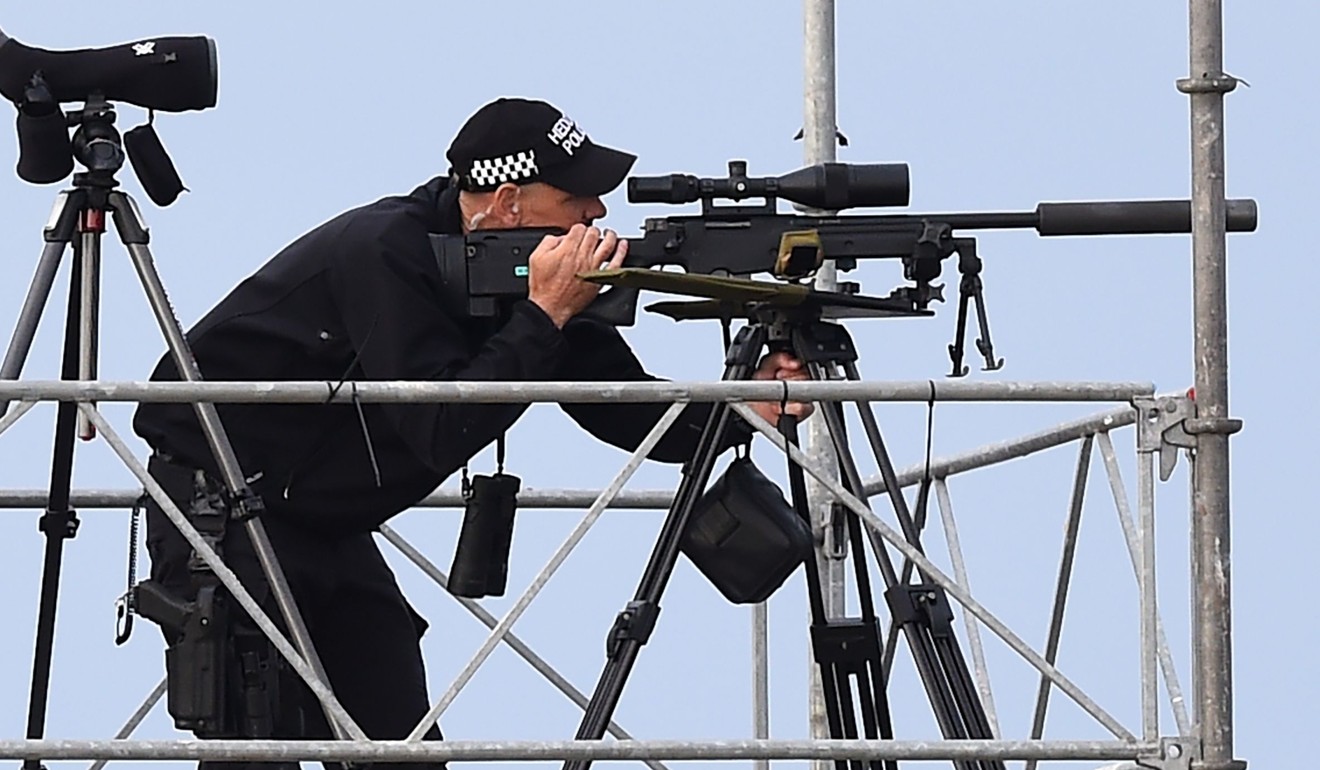 A police marksman awaits Trump’s arrival on Air Force One at Prestwick Airport, south of Glasgow on Friday. Photo: AFP