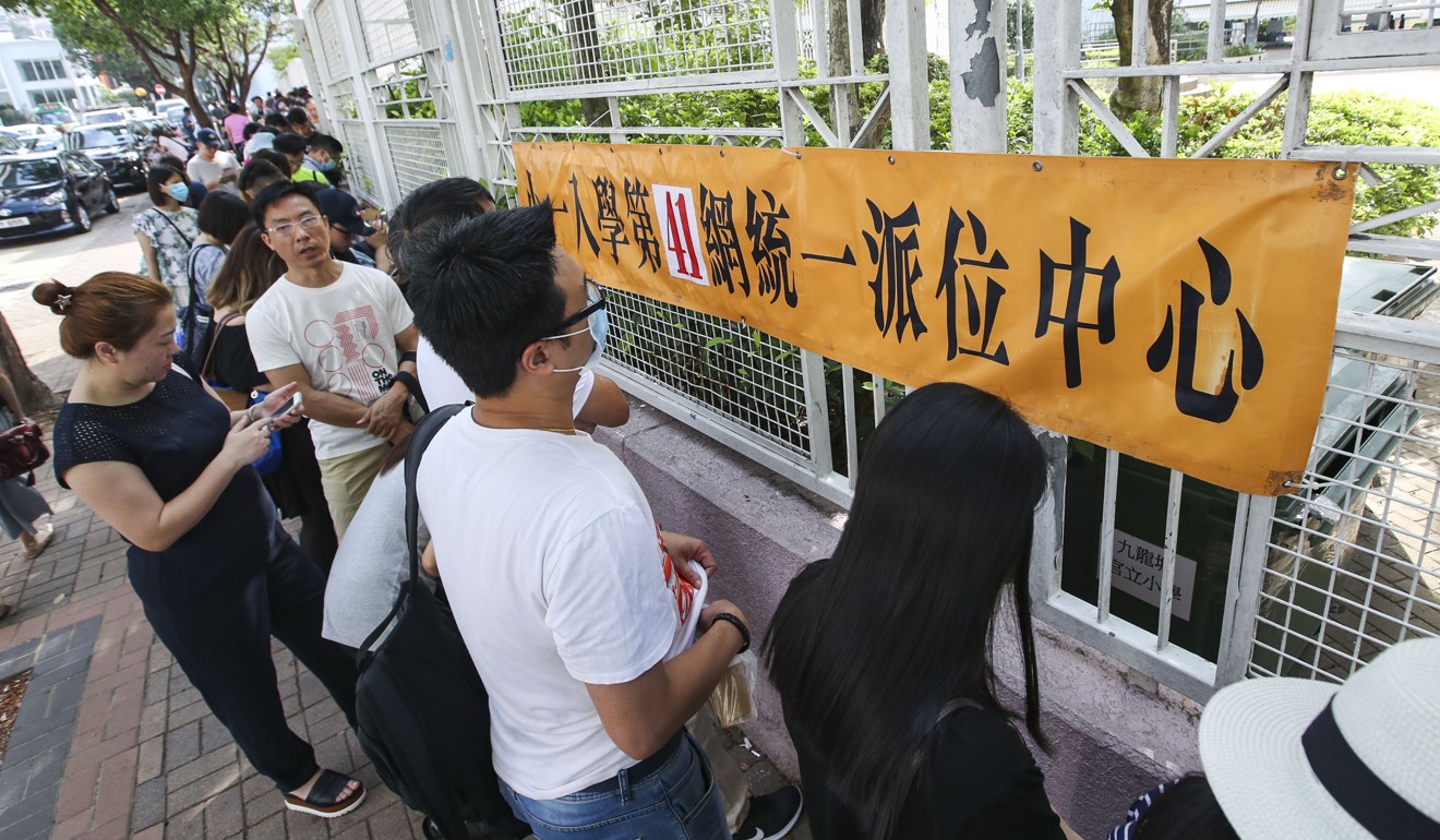 Students and parents queue up outside primary schools waiting for admissions results. Photo: Edward Wong