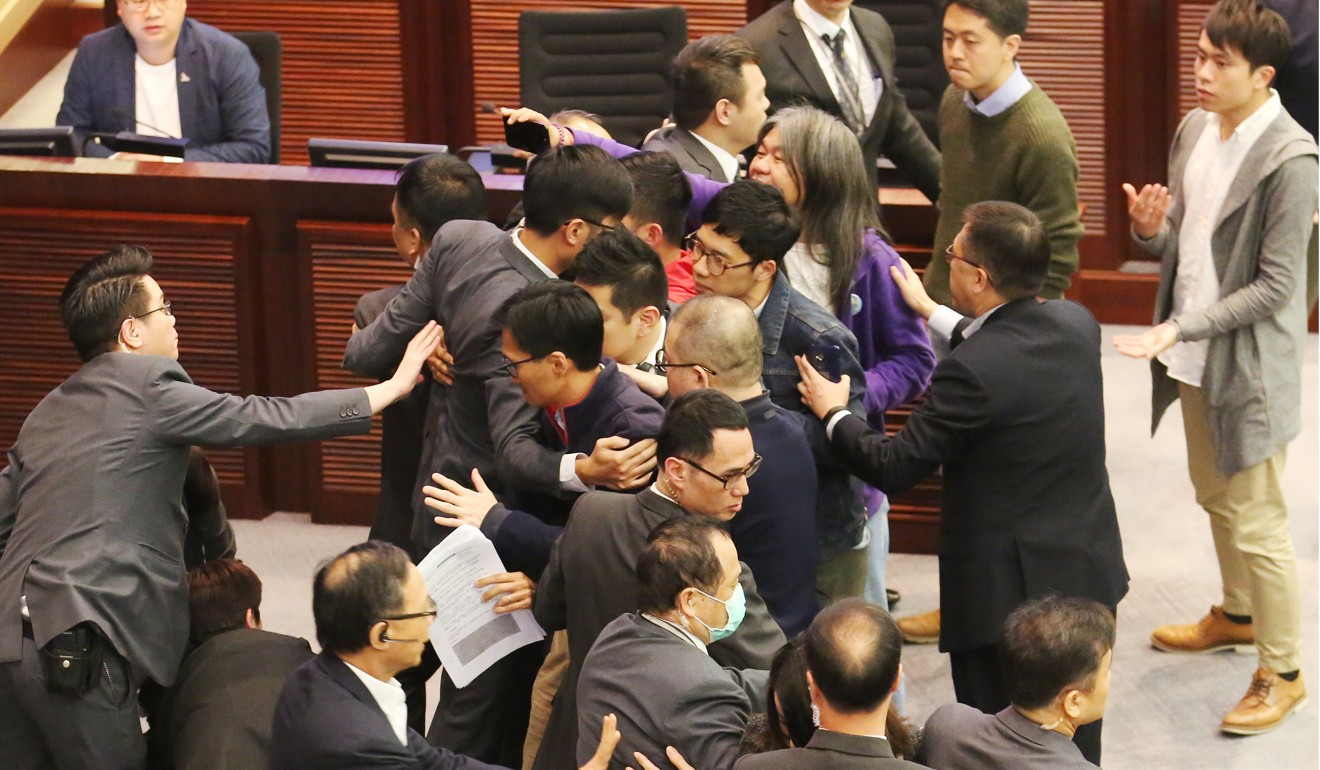 Protesting pan-democrat lawmakers try to stop the Finance Committee of Hong Kong’s Legislative Council from approving a funding package for more than 9,000 public works projects, including some controversial items they oppose, at a meeting in March 2017. The HK$12.4 billion funding package was eventually approved. Photo: Edward Wong