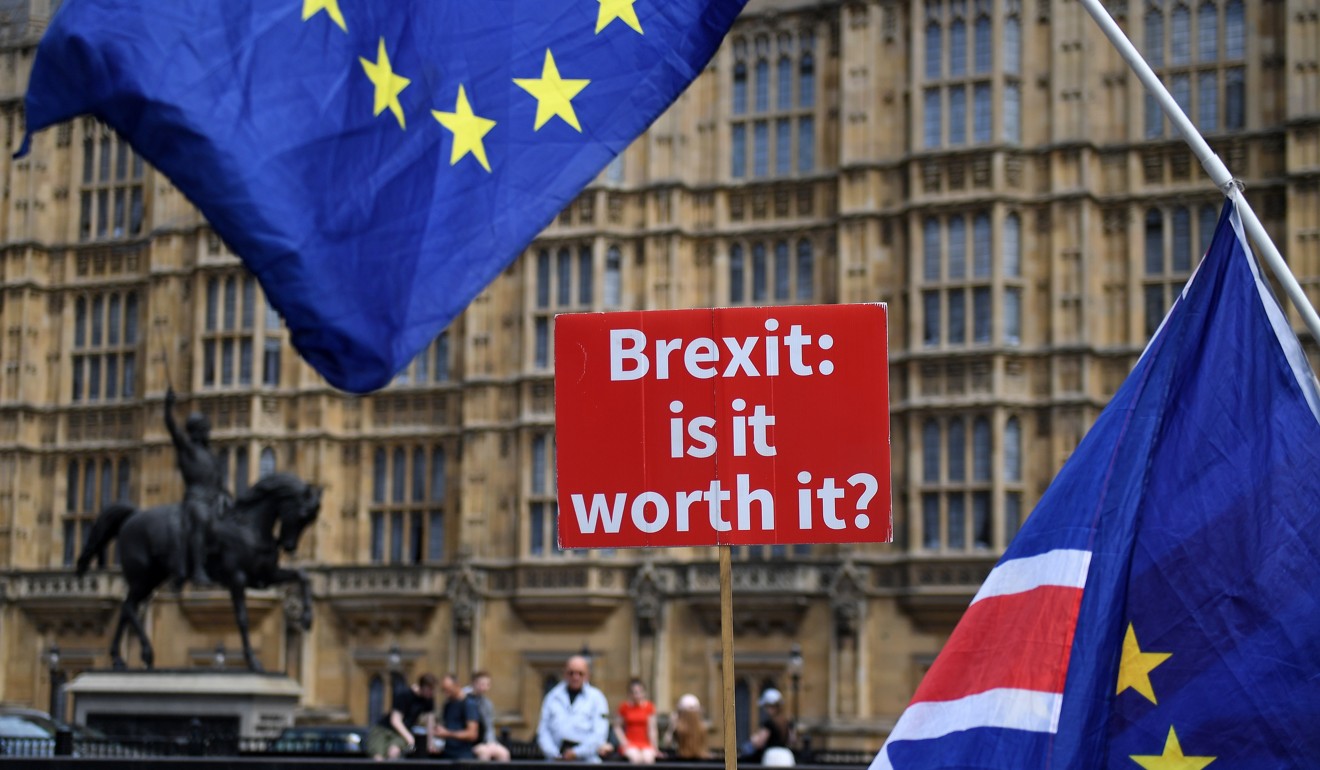 Anti-Brexit campaigners fly EU flags outside the British Houses of Parliament in London on Thursday. Photo: EPA-EFE