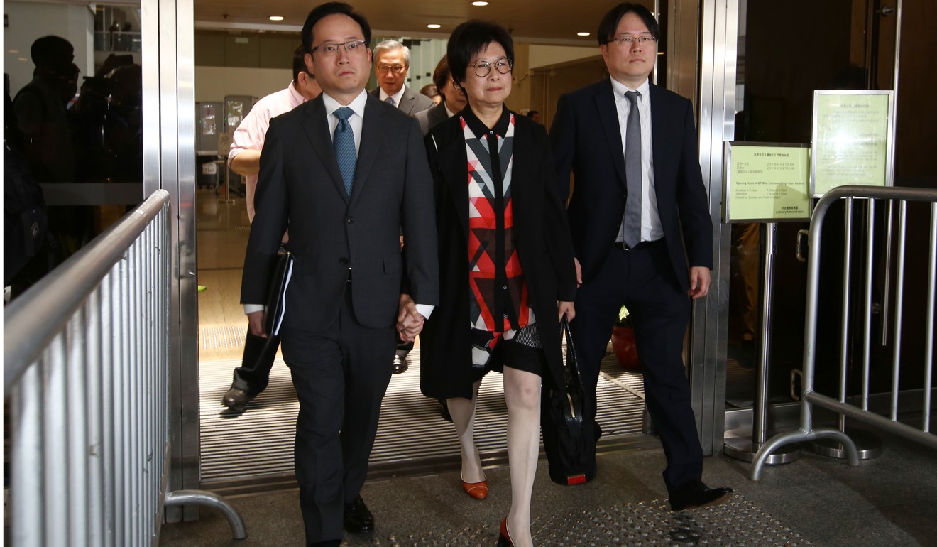 Donald Tsang’s wife, Selina Tsang, with their sons Thomas Tsang Hing-shun (left) and Simon Tsang Hing-yin (right) leaving court after learning the appeal result. Photo: Edmond So