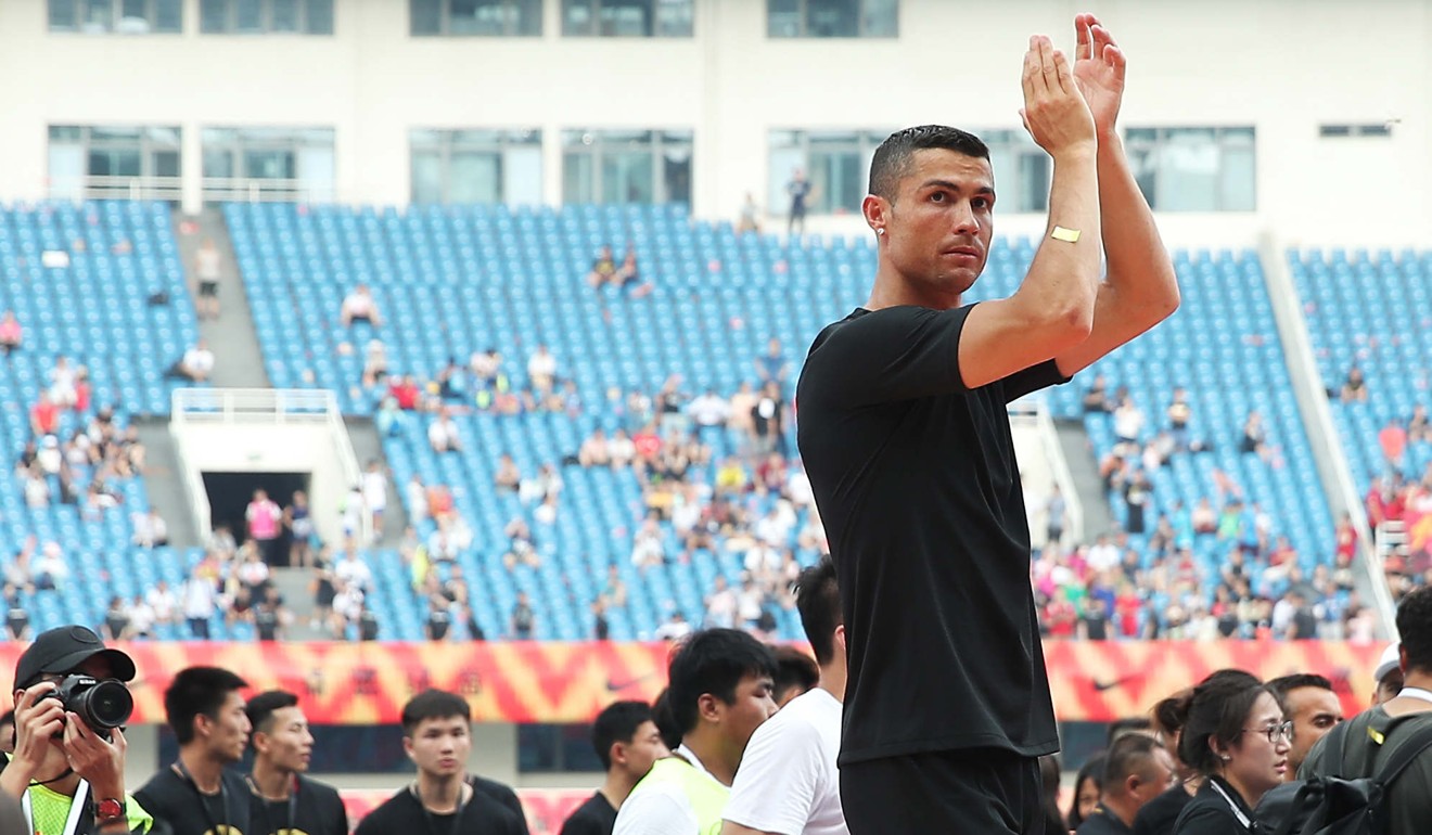 Ronaldo greets fans as he attends a promotional event in Beijing. Photo: Xinhua