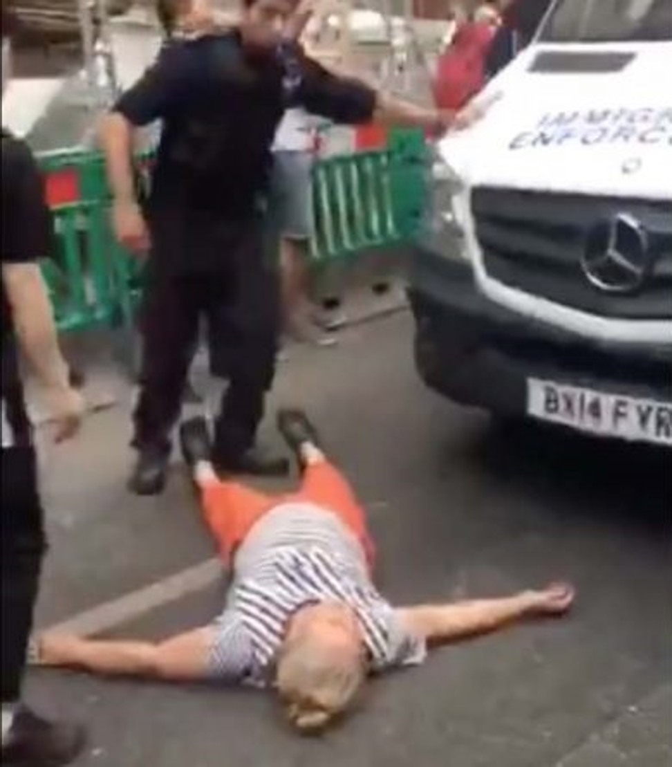 London Police with a woman in front of an immigration van on Gerrard Street in London's Chinatown, during July 5 raids. Photo: YouTube