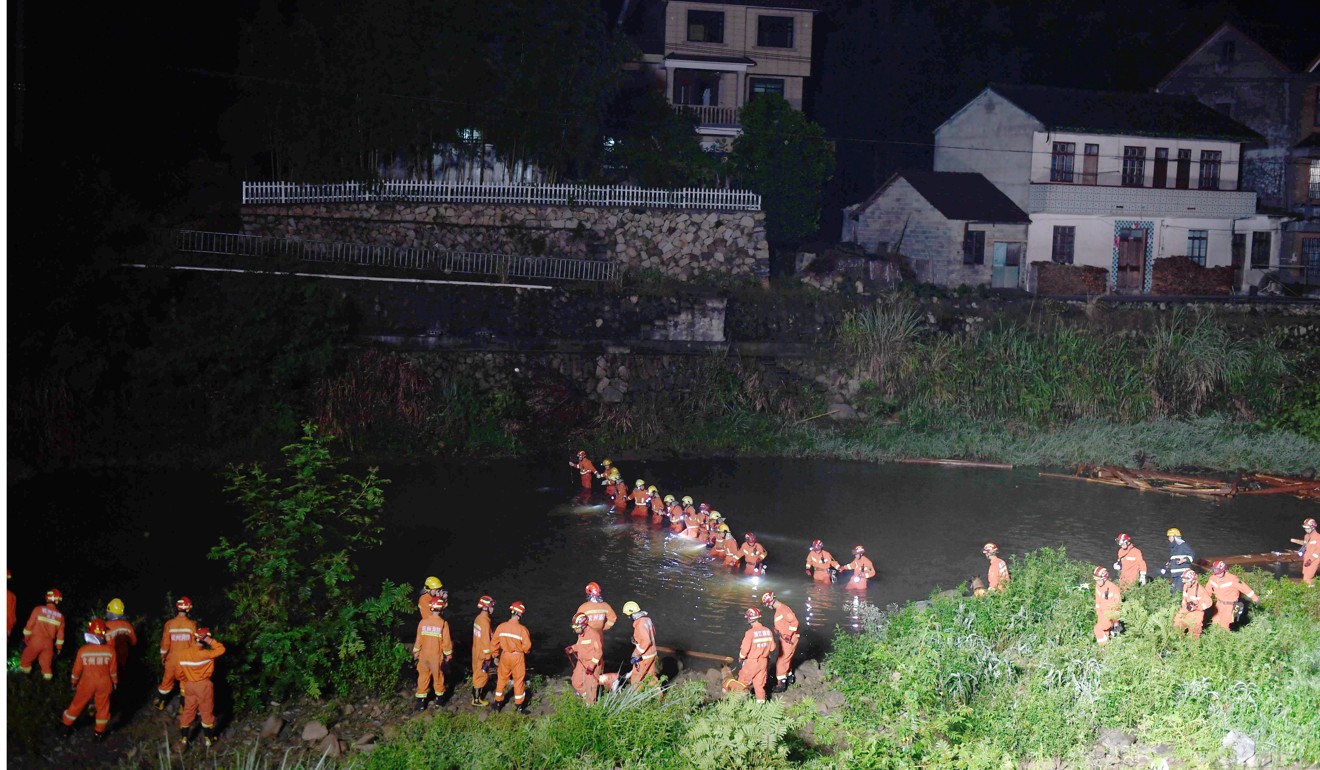 Rescuers search the river near the footbridge on Friday evening. Photo: Xinhua