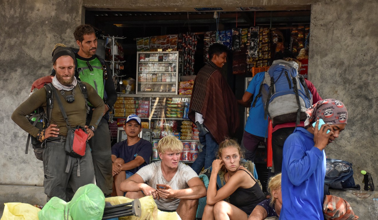 Indonesian and foreign climbers after walking down from Rinjani Mountain at Sembalun village in Lombok. Photo: Reuters