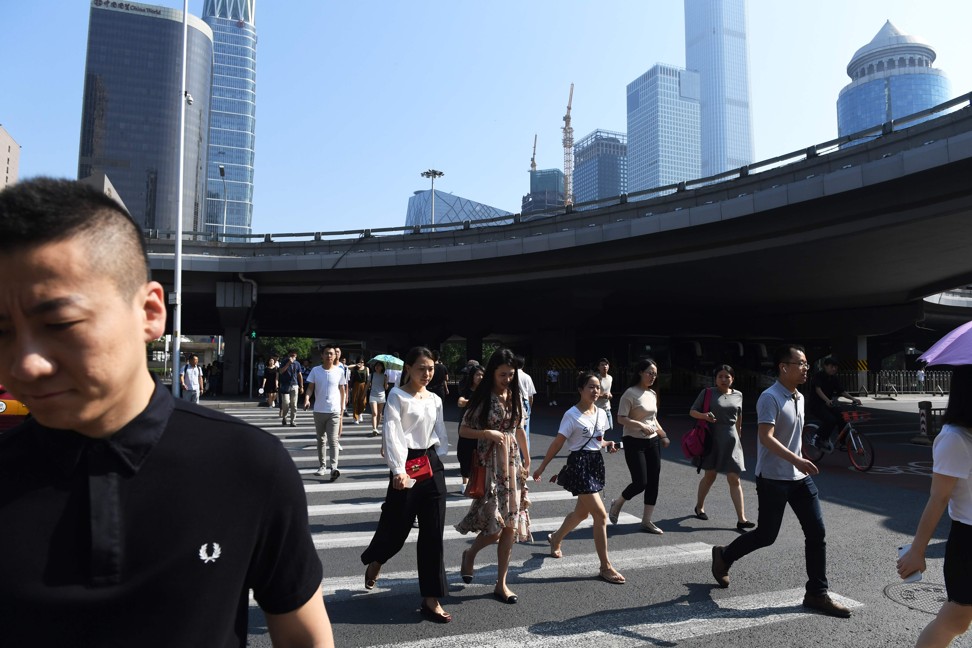 Commuters head to work in Beijing's central business district on July 6, 2018. The US is set to begin enforcing tariffs on more than US$34 billion in Chinese imports from July 6, with Beijing vowing to respond with its own tariffs immediately. Photo: AFP