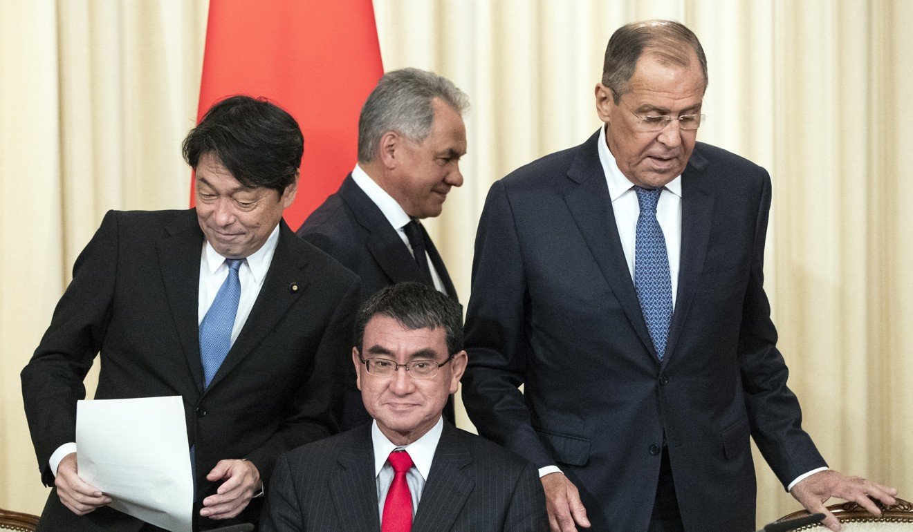 Russian Defence Minister Sergei Shoigu (centre top), Japanese Defence Minister Itsunori Onodera (left), Japanese Foreign Minister Taro Kono (centre sitting) and Russian Foreign Minister Sergey Lavrov arrive for a press conference on Tuesday in Moscow. Photo: AP