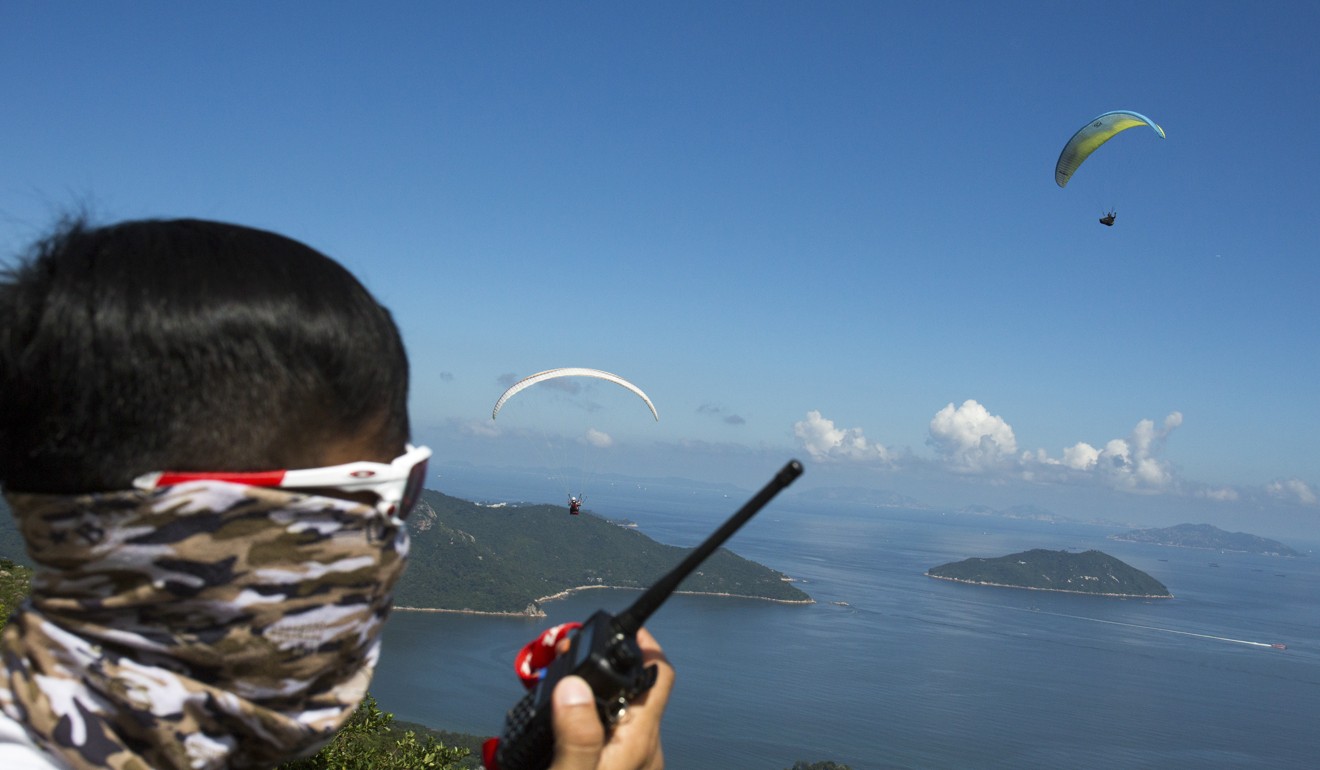 Pilots must carry a two-way radio and monitor an emergency channel shared by all paragliders. Photo: May Tse