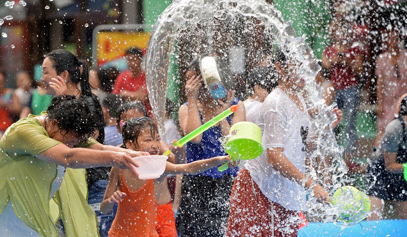 Fun at a water-sprinkling carnival amid the summer heat in Nanchang, capital of Jiangxi province. Photo: Xinhua