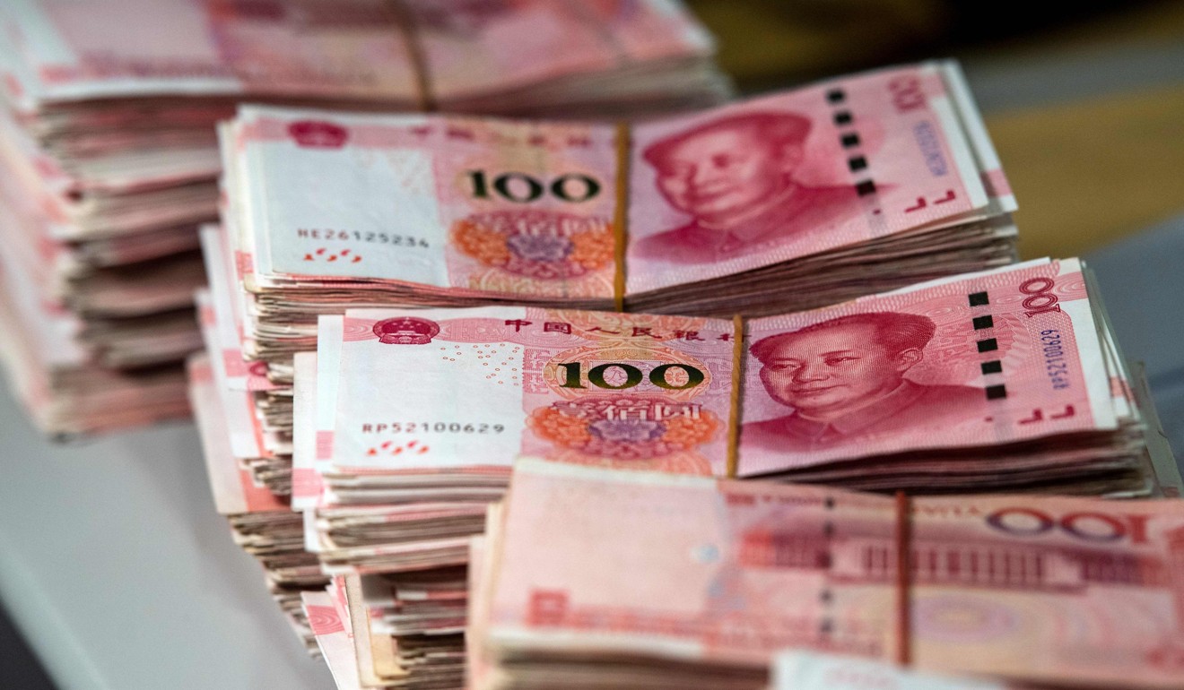 Bundles of 100 yuan notes at a bank in Shanghai on August 8. A rally in Asian markets stuttered on August 8, but the yuan got some support after a news report said the Chinese central bank had emphasised the need for currency stability to the country's lenders as it looks to halt a recent slide. Photo: AFP