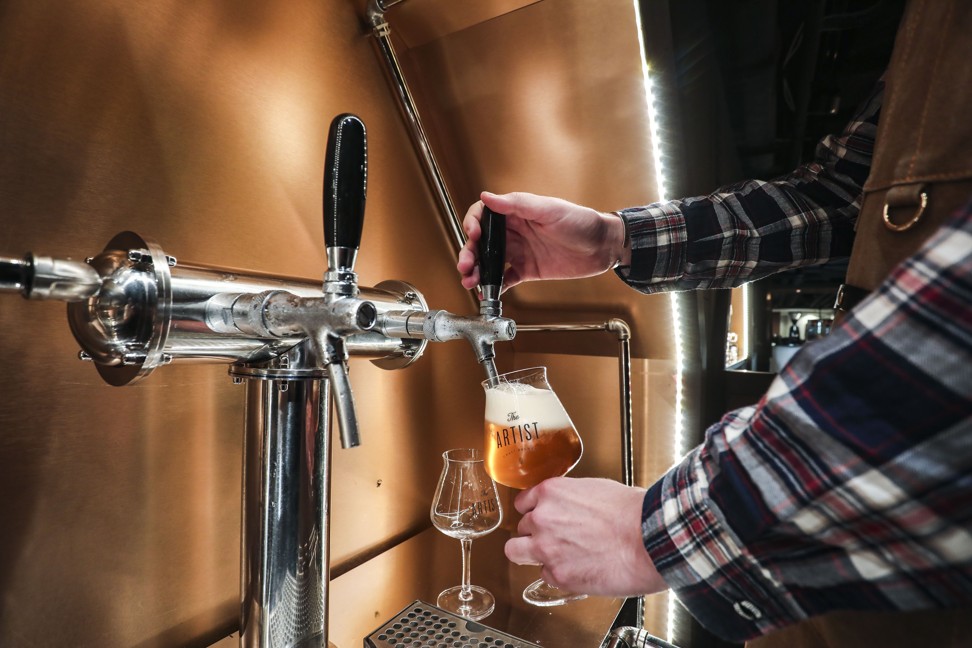 A glass of IPA is poured from the beer tap at The Artist House. Photo: Jonathan Wong