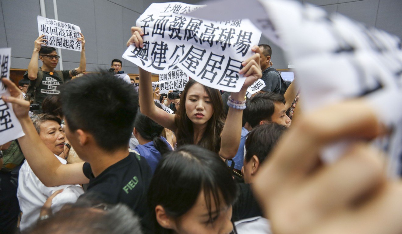 Activists protest during a public forum held by the Task Force on Land Supply at the Tai Po Community Centre in July. Photo: Xiaomei Chen