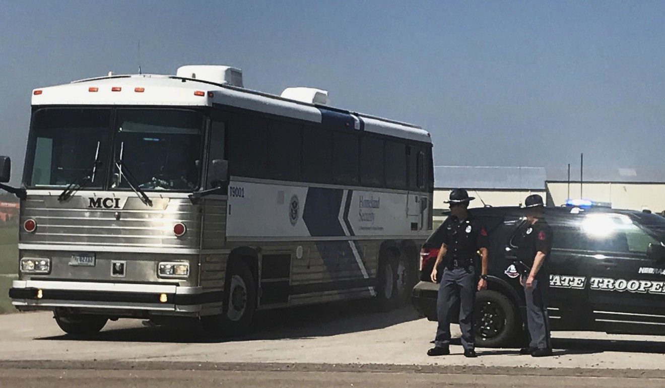 An ICE bus pulls out of a tomato plant in O'Neill, Nebraska after an immigration raid on August 8. Photo: Omaha World-Herald via AP