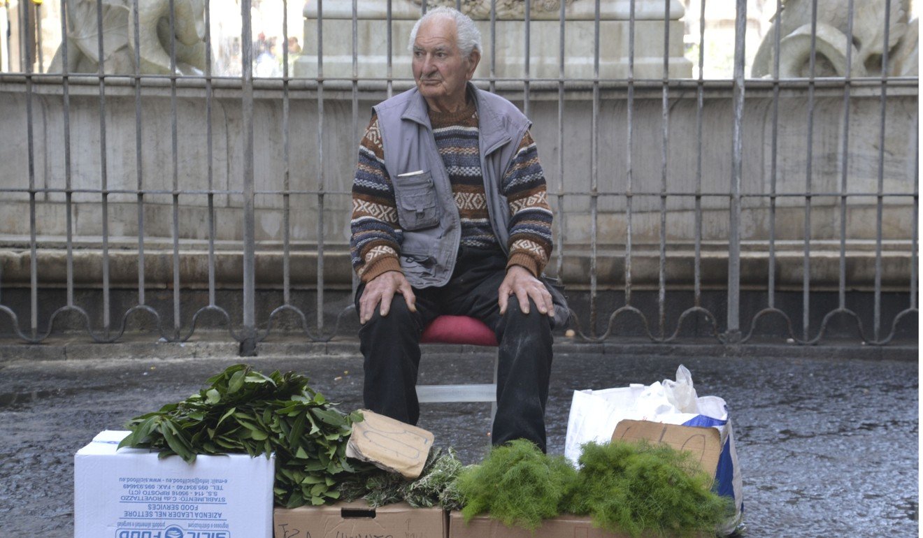 An elderly gentleman selling produce at the Catania market. Photo: Chris Dwyer