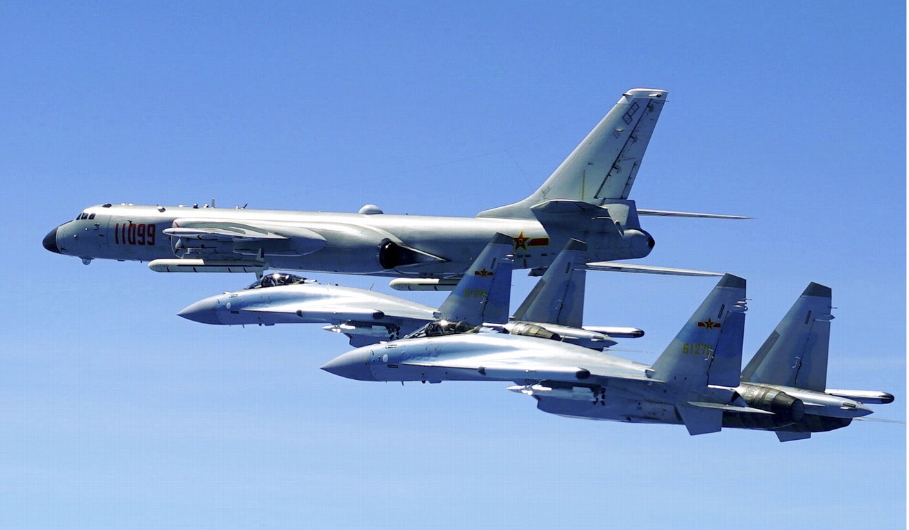 In this photo released by Xinhua News Agency and taken Friday, May 11, 2018, two Su-35 fighter jets and a H-6K bomber from the People's Liberation Army air force fly in formation during patrol that included the Luzon Straits also known as Bashi Straits near Taiwan. (Han Chao/Xinhua via AP)