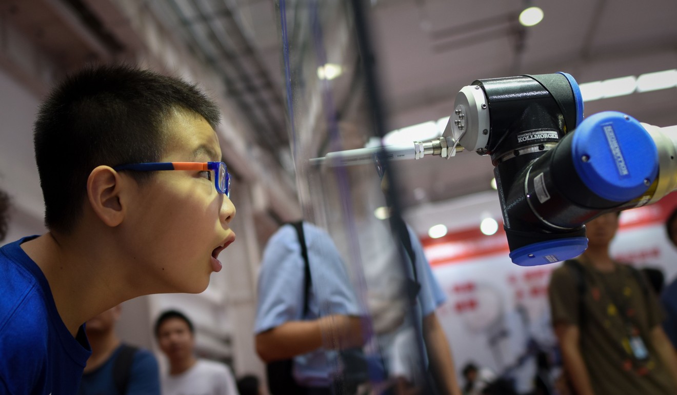 All eyes on a robot arm at the 2018 World Robot Conference in Beijing. Photo: AFP