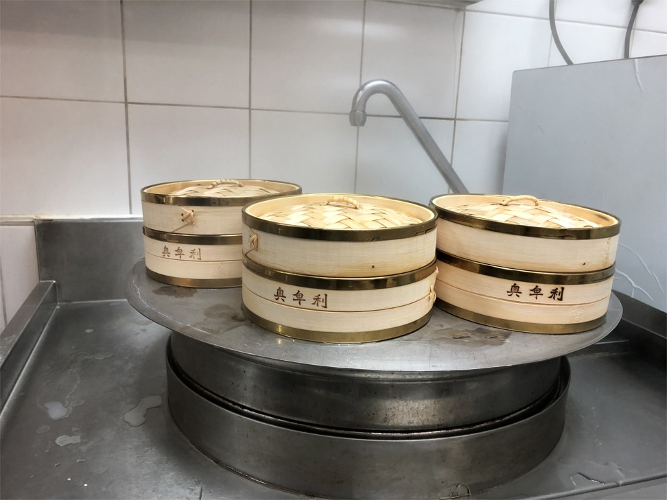 Bamboo baskets are placed on a steamer to cook the xiaolongbao inside.