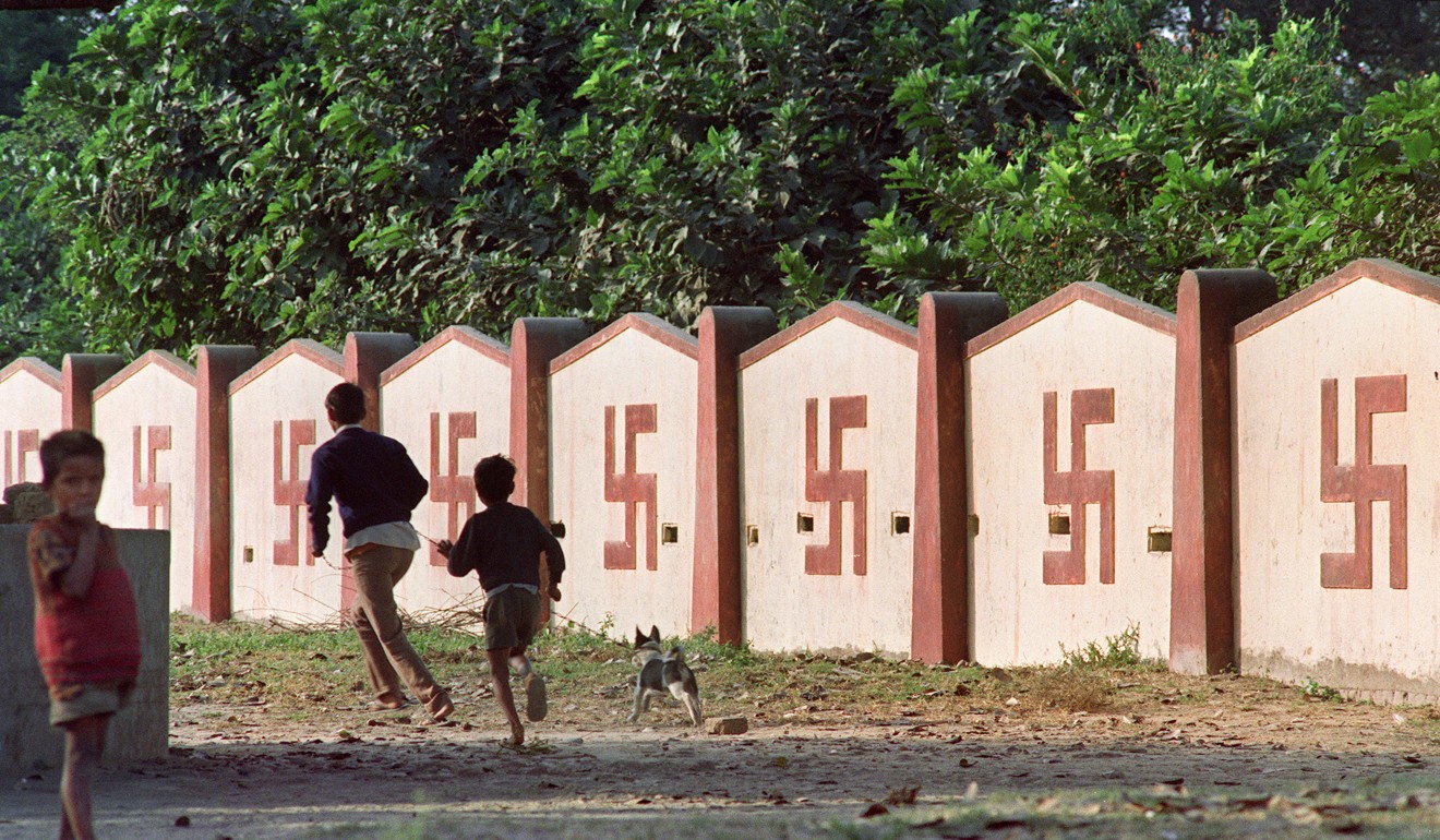 A wall covered with swastikas, a symbol of Hinduism, in Ayodhya. Photo: AFP