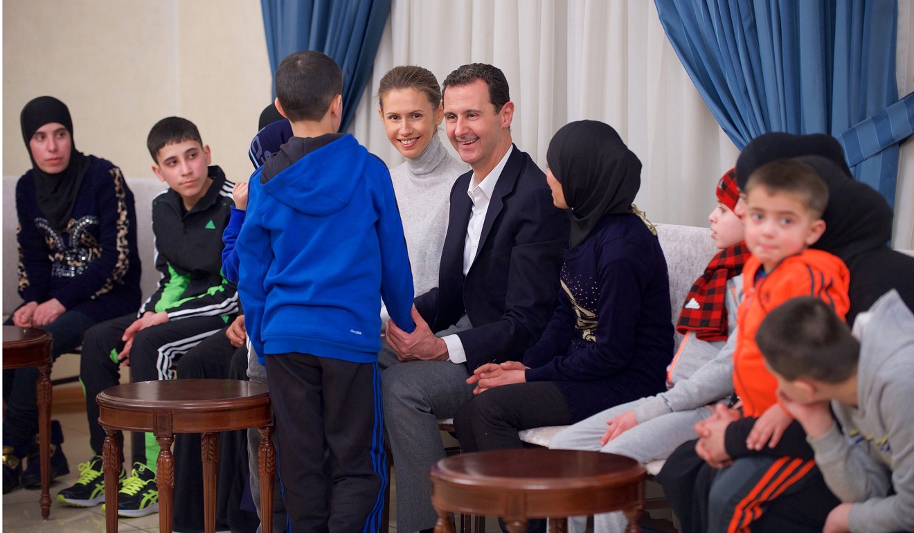 File photo of Syria’s President Bashar al-Assad and his wife Asma meeting women and children who were released after they had been abducted by Western-backed rebels. Photo: TNS