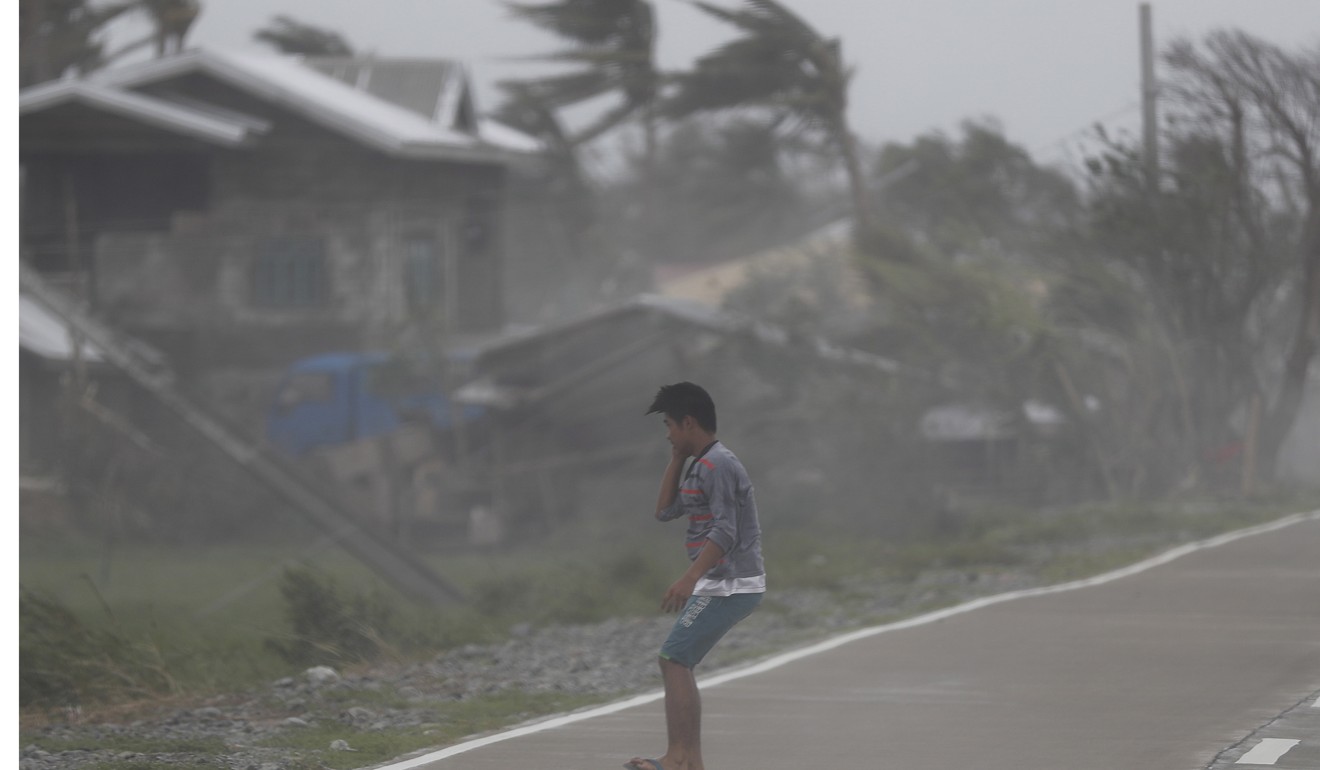Strong winds batter a villager in the typhoon-hit town of Baggao, Cagayan province, Philippines. Photo: EPA