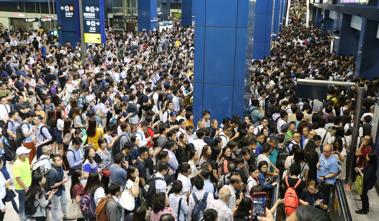 Commuters struggle to get to their trains at Tai Wai station. Photo: Felix Wong