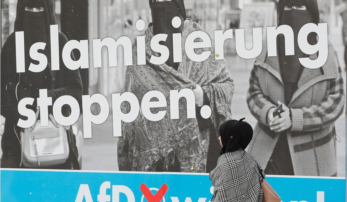 A woman walks past an election campaign poster of the anti-immigration party Alternative fuer Deutschland, in Marxloh, a suburb of Duisburg, Germany, on September 13, 2017. Photo: Reuters
