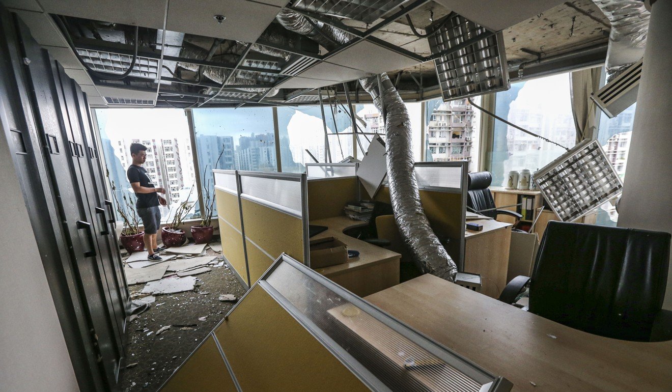 A tenant assesses damage at One Harbourfront in Whampoa. Photo: Felix Wong