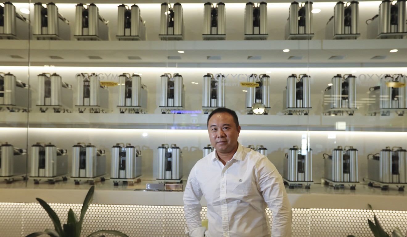 Vincent Li, founder and CEO of Oxygym, with his oxygen machines. Photo: Simon Song