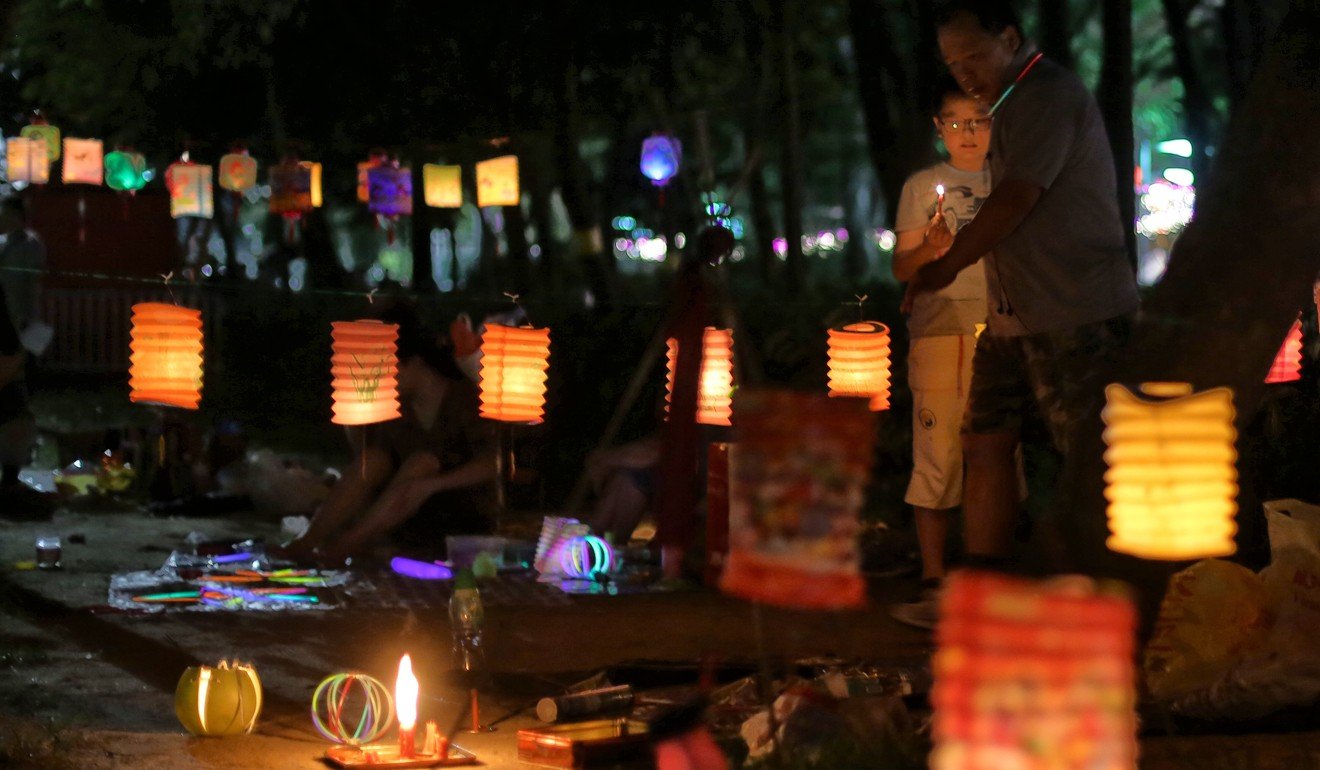 A father and son hanging lanterns at Victoria Park in Causeway Bay. Photo: Sam Tsang