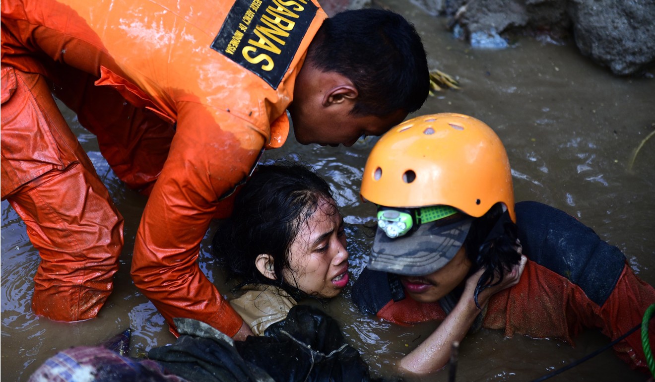 Indonesian rescuers try to free a 15-year-old earthquake survivor, Nurul Istikhomah from the flooded ruins of a collapsed house in Palu, Central Sulawesi. Photo: EPA