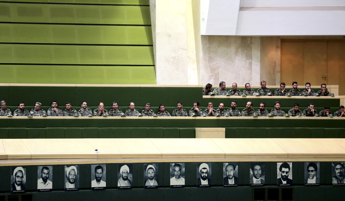 Members of the Iranian Revolutionary Guard listen to a speech in parliament in Tehran regarding the bill to counter terrorist financing. Photo: AFP
