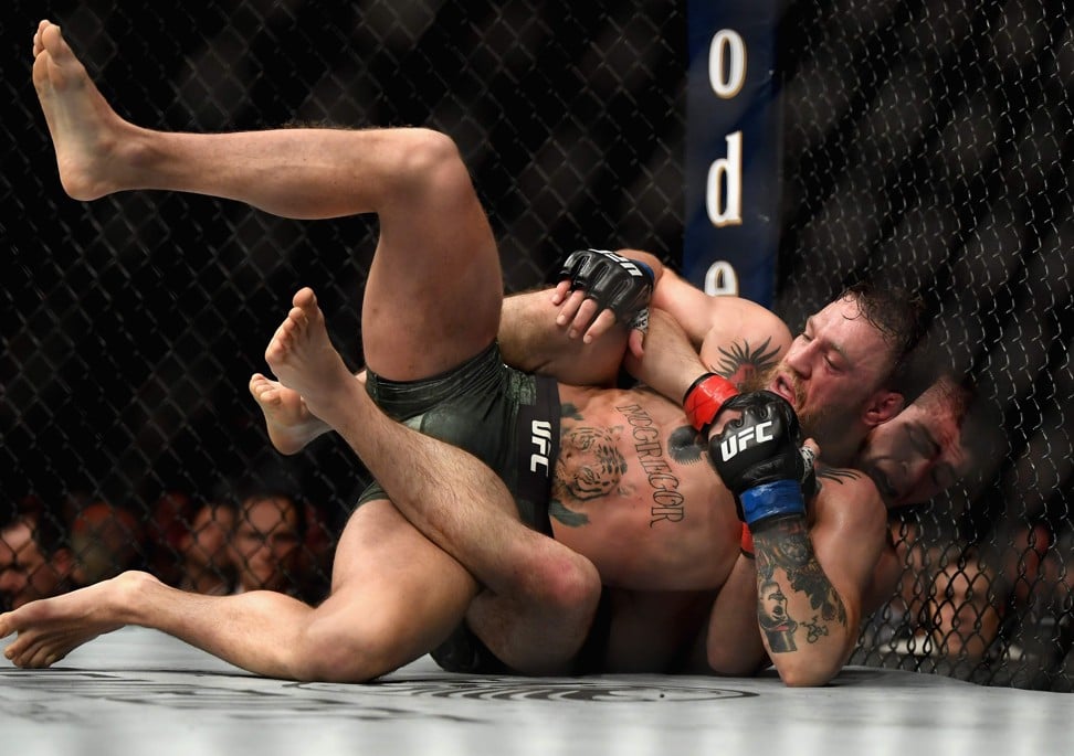 Khabib Nurmagomedov holds down Conor McGregor during their UFC fight. Photo: AFP