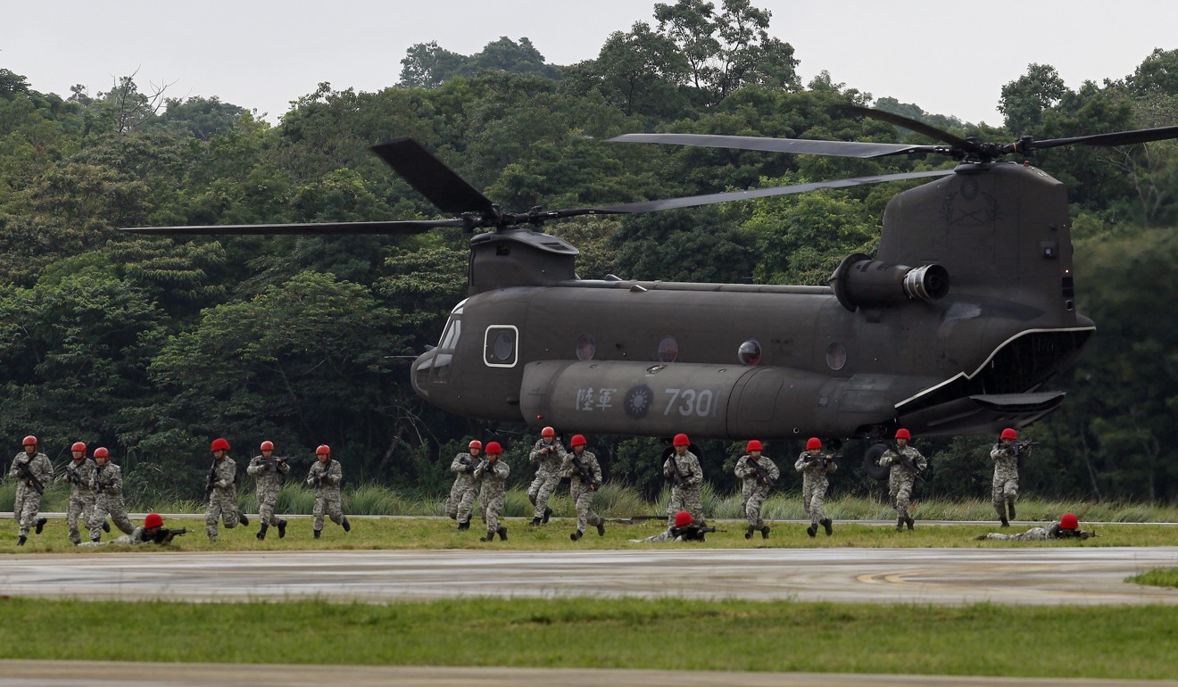 Fictitious enemy soldiers from Taiwan’s special forces exit from a CH-47SD Chinook helicopter during the drill on Tuesday. Photo: AP