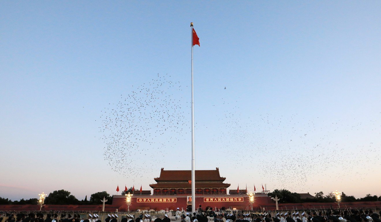 A national flag raising ceremony is held at Tiananmen Square in Beijing. Photo: Xinhua