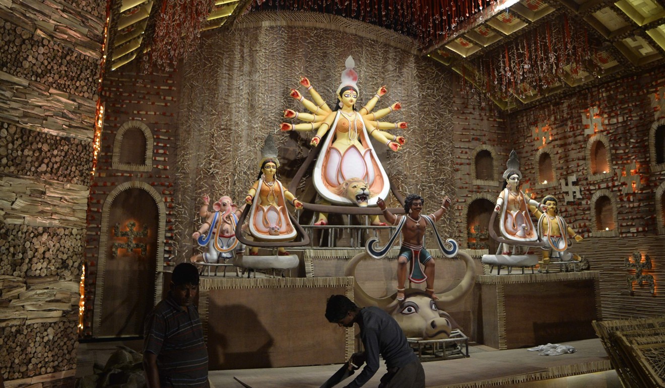 Indian workers finish a pandal last week in the lead-up to the Durga Puja festival. Photo: AFP