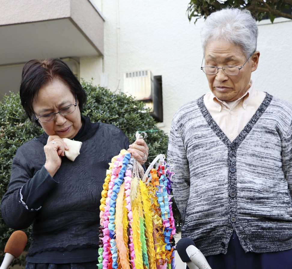 Jumpei Yasuda’s parents outside their home in Iruma, northwest of Tokyo. Photo: AP