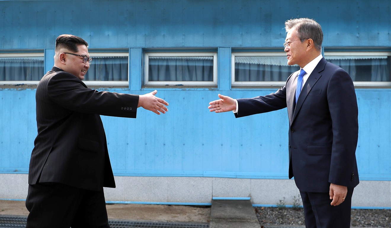 Kim and Moon prepare for a historical handshake over the military demarcation line at the border village of Panmunjom. Photo: AP