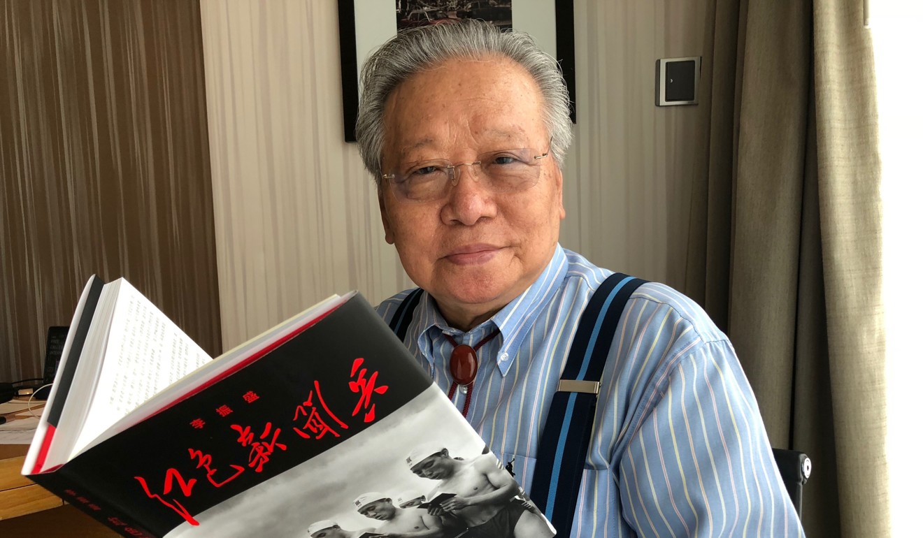 Li Zhensheng with a Chinese language copy of his book. Photo: Josephine Ma