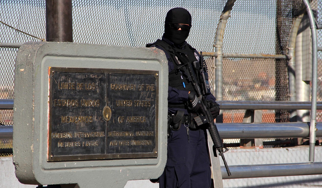 A US customs and border patrol agent stands guard on the US-Mexico international bridge. Photo: AFP