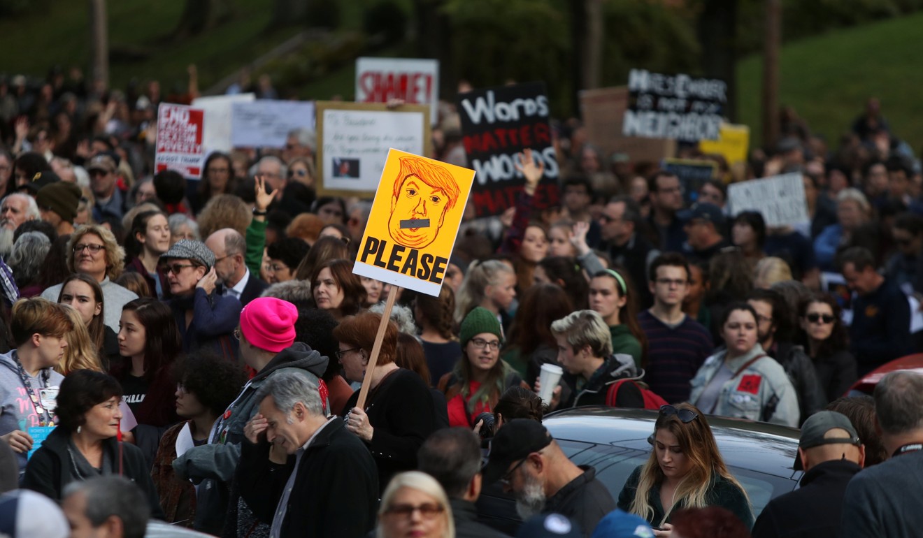 A participant in the march in memory of the victims of the Tree of Life Synagogue shooting, holds a sign opposing US President Donald Trump in Pittsburgh, Pennsylvania, on Tuesday. Photo: Reuters