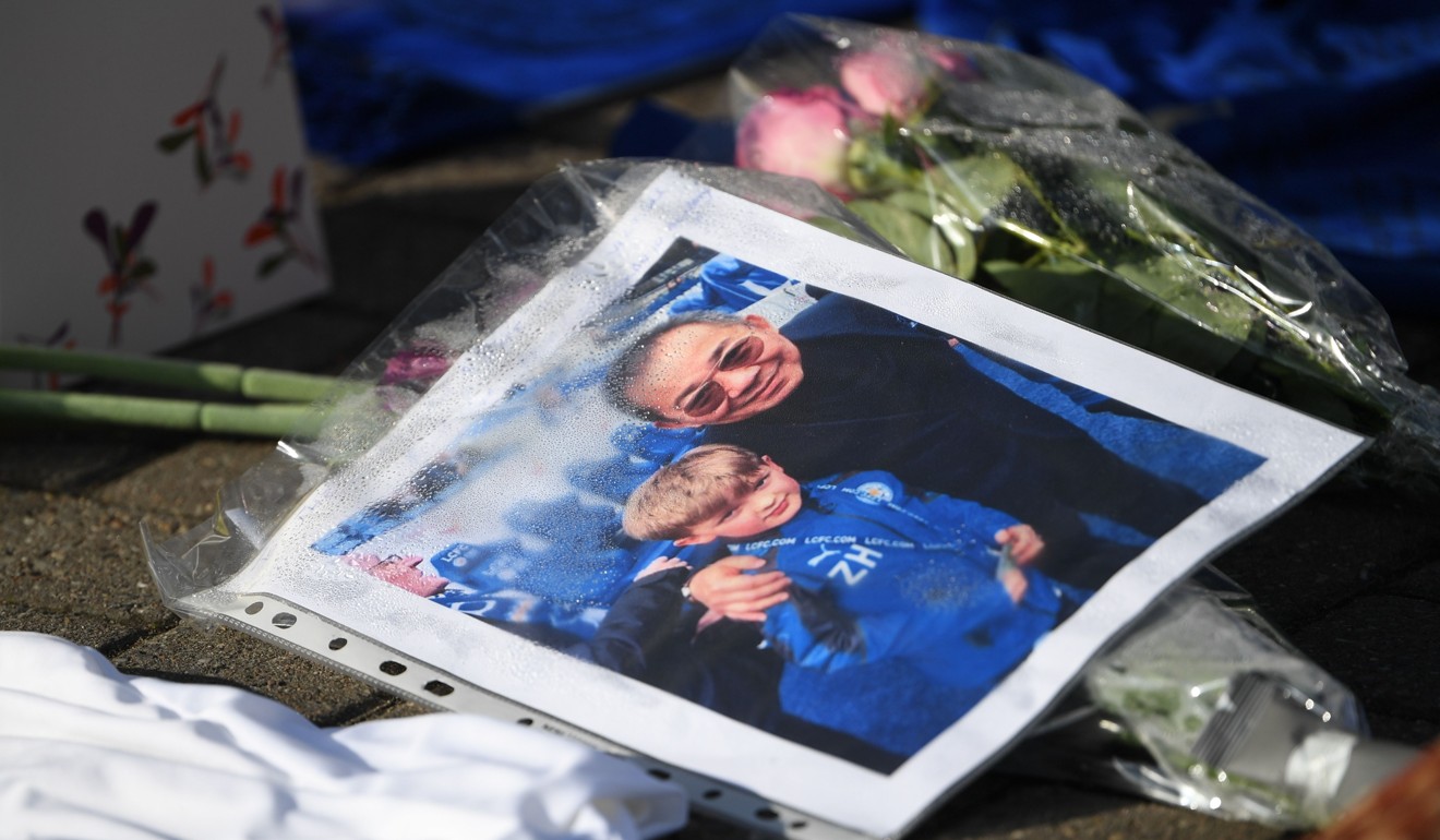 A photograph of a boy posing with Vichai Srivaddhanaprabha is seen among the tributes gathered outside Leicester City’s King Power Stadium. Photo: AFP