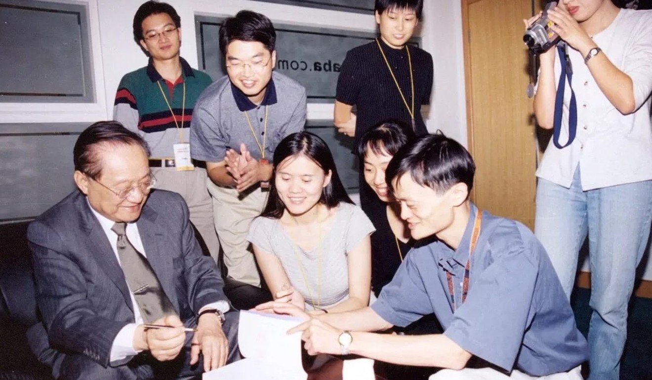 Louis Cha (left) signs an autograph for Jack Ma (second from right) and Lucy Peng (centre in front row), CEO of Lazada, an e-commerce firm owned by Alibaba. Photo: Handout