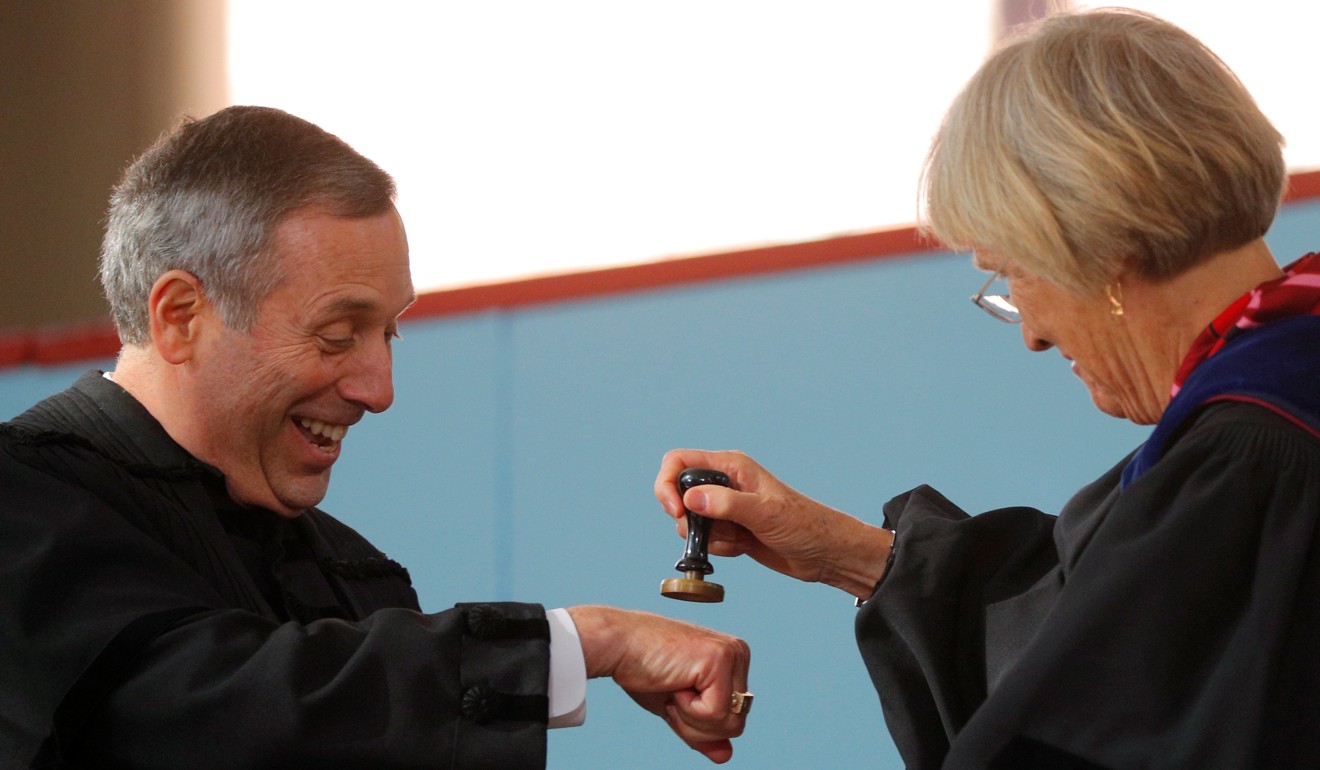 Former Harvard president Drew Faust pretends to stamp the hand of Lawrence Bacow with the great seal of the university, during Bacow's inauguration as the 29th President of Harvard University in Cambridge, Massachusetts, on October 5. Photo: Reuters