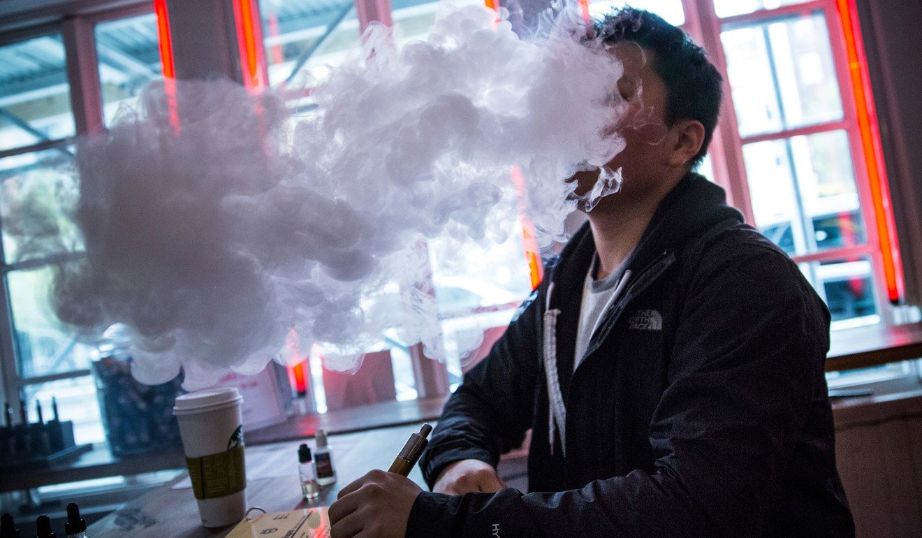 A smokes an electronic cigarette, at Henley Vaporium in New York City. Photo: Agence France-Presse