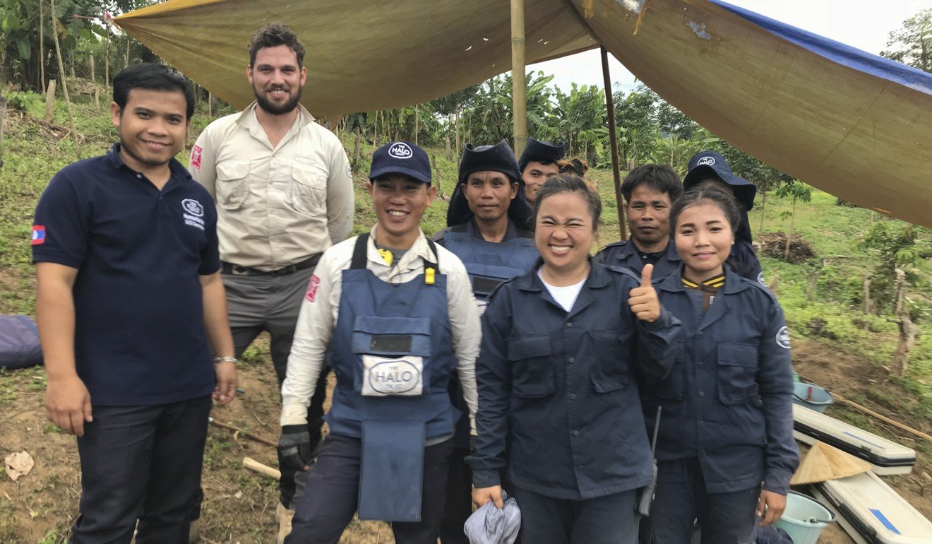 Calum Gibbs (second from left) and local personnel of the Halo Trust at a field site in Xépôn. Picture: Padraic Convery