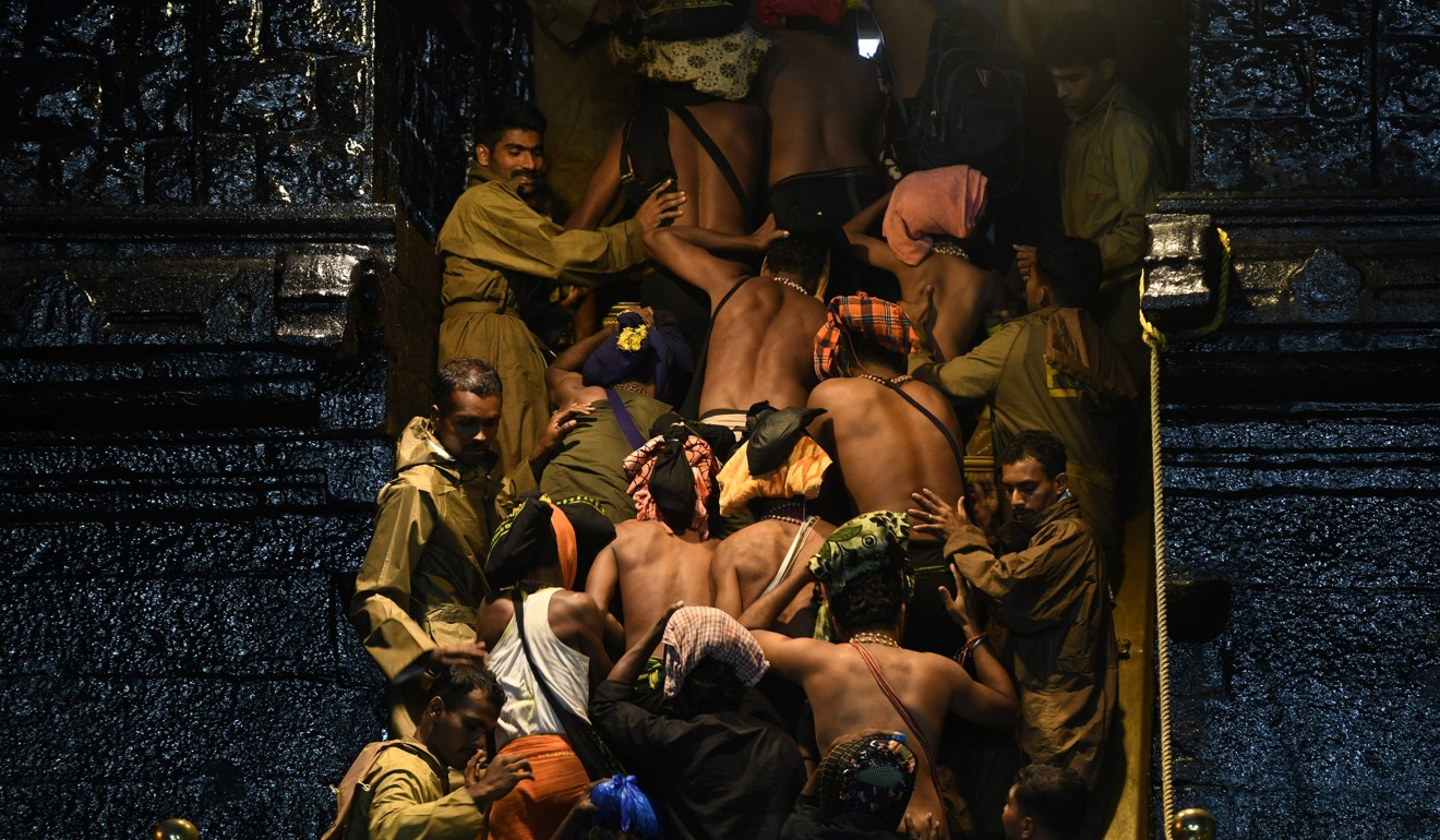 Indian Hindu devotees climb over the holy eighteen golden steps to worship Hindu god Ayyapa at a temple premises in Sabarimala in the southern state of Kerala. Indian police mounted a major security operation on November 16 to prevent hardliners blocking women from entering the site. Photo: AFP